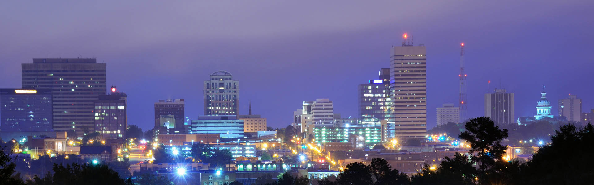 Neon color image of a band playing and people singing along