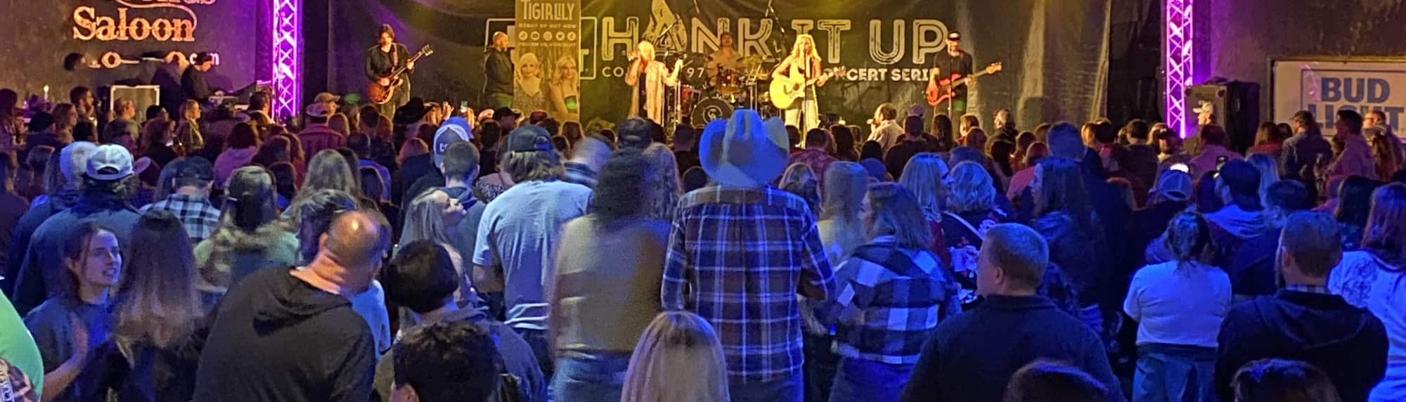 country concert with fans wearing cowboy hats Columbia